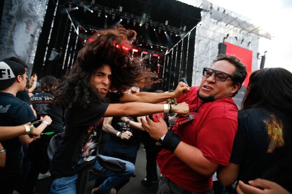 Fans of Swedish heavy metal band Avatar mosh during their performance at the Domination music festival in Mexico City, Friday, May 3, 2019. (AP Photo/Eduardo Verdugo)