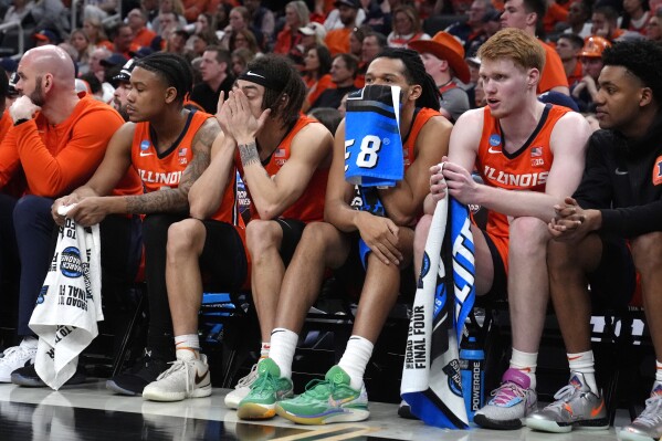 Illinois rest on the bench while trailing UConn during the second half of the Elite 8 college basketball game in the men's NCAA Tournament, Saturday, March 30, 2024, in Boston. (AP Photo/Steven Senne)