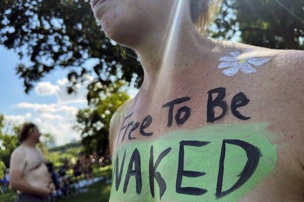 A rider poses at the start of the Philly Naked Bike Ride in Philadelphia, Saturday, Aug. 26, 2023. (AP Photo/Tassanee Vejpongsa)