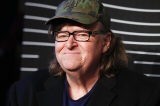 FILE - In this May 16, 2016 file photo, Michael Moore attends the 20th Annual Webby Awards at Cipriani Wall Street in New York. Social media users are falsely claiming that a clip from Moore's 2016 film "Michael Moore in TrumpLand" shows the documentarian supporting former President Donald Trump. (Photo by Andy Kropa/Invision/AP, File)