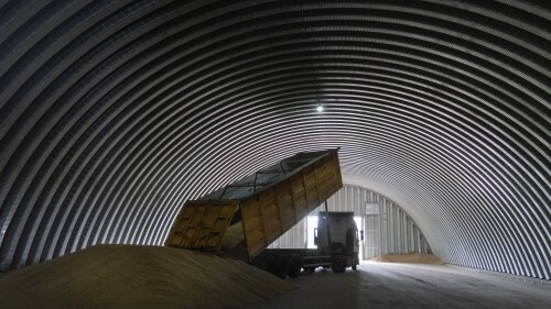 FILE - A dump track unloads grain in a granary in the village of Zghurivka, Ukraine, Tuesday, Aug. 9, 2022. European Union agriculture ministers are meeting to discuss ways of moving grain vital to global food security out of Ukraine after Russia halted a deal that allowed the exports. At the same time, they want to protect prices for farmers in countries bordering the war-ravaged nation. The ministers are meeting Tuesday, July 25, 2023 in Brussels for the first time since Russia pulled the plug on the wartime deal last week.(AP Photo/Efrem Lukatsky, File)