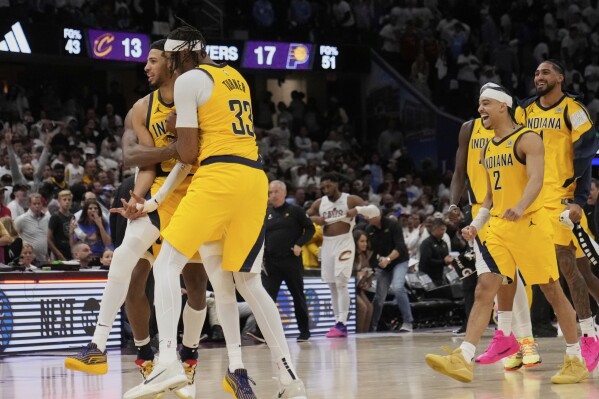 From left, Indiana Pacers Tyrese Haliburton, Myles Turner, Andrew Nembhard (2) and Obi Toppin, right, celebrate after defeating the Cleveland Cavaliers in Game 2 in the Eastern Conference semifinals of the NBA basketball playoffs Tuesday, May 6, 2025, in Cleveland. (AP Photo/Sue Ogrocki)