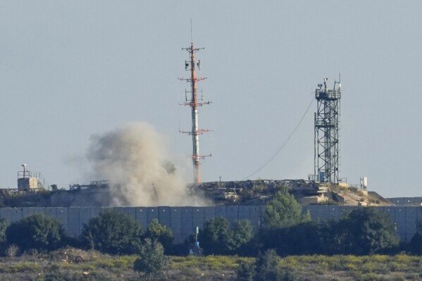 Smoke rises from inside an Israeli army position which was hit by Hezbollah fighters as seen from Tair Harfa village, a Lebanese border village with Israel, south Lebanon, Friday, Oct. 20, 2023. (AP Photo/Hassan Ammar)