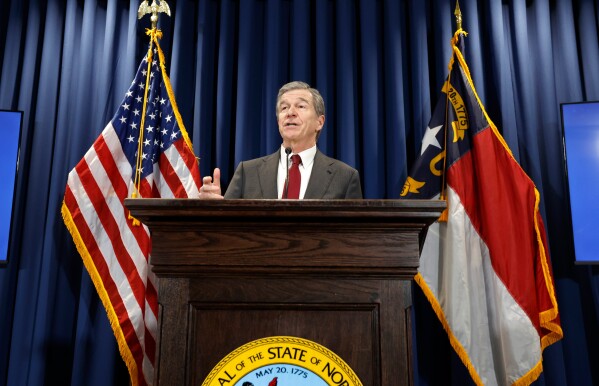 Gov. Roy Cooper talks about what is in his budget adjustment bill during a press conference in Raleigh, N.C., Wednesday, April 24, 2024. (Ethan Hyman/The News & Observer via AP)