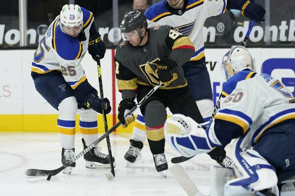 St. Louis Blues center Jordan Kyrou (25) and Vegas Golden Knights center Jonathan Marchessault (81) vie for the puck during the second period of an NHL hockey game Tuesday, Jan. 26, 2021, in Las Vegas. (AP Photo/John Locher)