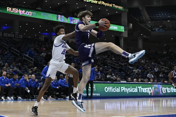 Northwestern forward Nick Martinelli, right, drives to the basket against DePaul forward Jeremiah Oden (25) during the first half of an NCAA college basketball game, Saturday, Dec. 16, 2023, in Chicago. (AP Photo/Matt Marton)