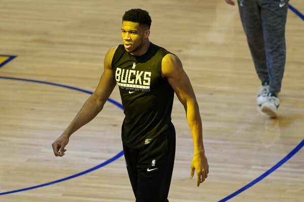 Milwaukee Bucks forward Giannis Antetokounmpo walks on the floor while practicing before an NBA basketball game between the Golden State Warriors and the Bucks in San Francisco, Tuesday, April 6, 2021. (AP Photo/Jeff Chiu)