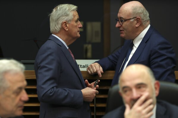 
              European Union chief Brexit negotiator Michel Barnier, top left, talks to European...