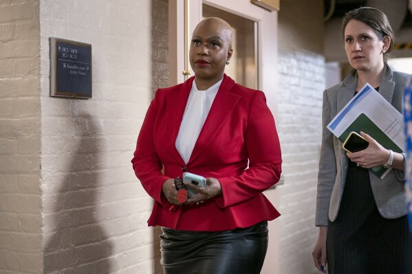 FILE - In this Wednesday, March 11, 2020, file photo, Rep. Ayanna Pressley, D-Mass., and other House Democrats arrive to meet with Speaker of the House Nancy Pelosi, D-Calif., on Capitol Hill in Washington. Democratic lawmakers are calling out an apparent lack of racial data that they say is needed to monitor and address disparities in the national response to the coronavirus outbreak. Massachusetts Sen. Elizabeth Warren and Rep. Ayanna Pressley say in a letter to Health and Human Services Secretary Alex Azar dated Friday, March 27, 2020, that comprehensive demographic data on people who are tested or treated for the coronavirus does not exist. (AP Photo/J. Scott Applewhite, File)