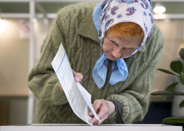 
              A woman casts her ballot at a polling station during the second round of voting in presidential elections in Vilnius, Lithuania, Sunday, May 26, 2019. (AP Photo/Mindaugas Kulbis)
            