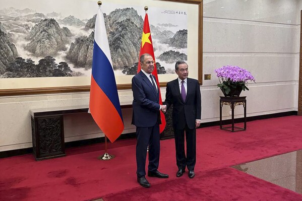 In this photo released by Russian Foreign Ministry Press Service in their telegram channel on Tuesday, April 9, 2024, Russian Foreign Minister Sergey Lavrov, left, and Chinese Foreign Minister Wang Yi pose for a photo during their meeting in Beijing, China. (Russian Foreign Ministry Press Service telegram channel via AP)