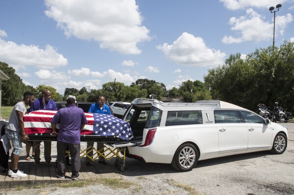 FILE - The body of New Orleans Police detective Everett Briscoe is placed into a hearse before it is escorted from the Respect for Life Funeral Home for the journey back to New Orleans, Tuesday, Aug. 24, 2021, in Houston. Frederick Jackson has pleaded guilty in the fatal shooting of off-duty officer Briscoe and his friend during a holdup at a Houston restaurant in 2021, prosecutors announced Wednesday, May 15, 2024. (Brett Coomer/Houston Chronicle via AP)