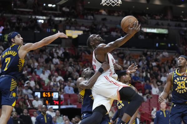 Miami Heat center Bam Adebayo, center, goes up for a shot during the second half of an NBA basketball game against the Indiana Pacers, Wednesday, Feb. 8, 2023, in Miami. (AP Photo/Wilfredo Lee)
