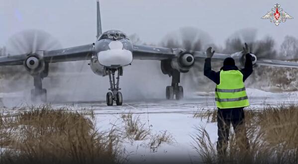 In this handout photo taken from video released by the Russian Defense Ministry Press Service on Wednesday, Nov. 30, 2022, a view of a Tu-95 strategic bomber of the Russian air force taxiing before takeoff for a joint air patrol with Chinese bombers at an airbase in an unspecified location in Russia. Russian and Chinese strategic bombers on Wednesday flew a joint patrol over the western Pacific in a show of increasingly close defense ties between the two countries. (Russian Defense Ministry Press Service via AP)