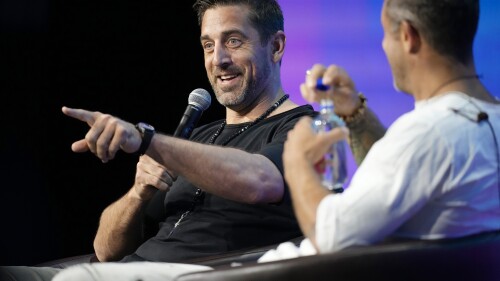 New York Jets quarterback Aaron Rodgers, back, chats with entrepreneur Aubrey Marcus during a program at the Psychedelic Science conference in the Colorado Convention Center Wednesday, June 21, 2023, in Denver. (AP Photo/David Zalubowski)