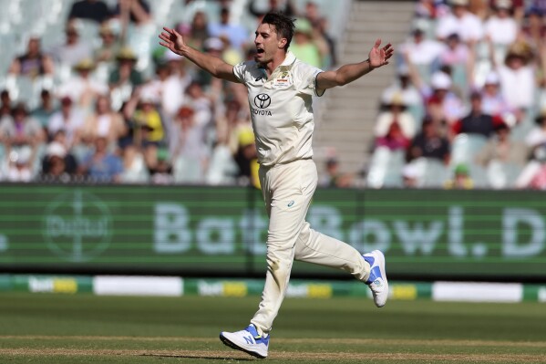 Australia's Pat Cummins celebrates taking the wicket of Pakistan's Agha Salman during the second day of their cricket test match in Melbourne, Wednesday, Dec. 27, 2023. (AP Photo/Asanka Brendon Ratnayake)