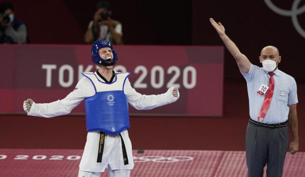 Vladislav Larin of the Russian Olympic Committee, left, reacts as the referee signals his win for a gold medal for taekwondo men's 80kg match at the 2020 Summer Olympics, Tuesday, July 27, 2021, in Tokyo, Japan. (AP Photo/Themba Hadebe)