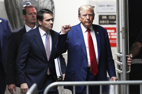 Former President Donald Trump, followed by attorney Todd Blanche, left, gestures as he returns from a break in his trial at Manhattan criminal court in New York, Friday, Friday, May 10, 2024. (Curtis Means/DailyMail.com via AP, Pool)
