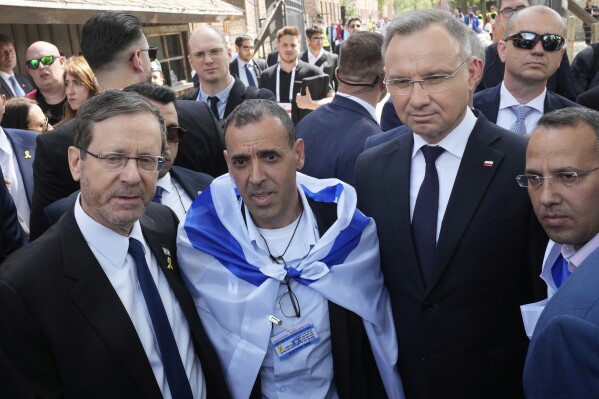 Poland's President Andrzej Duda, right, and his Israel's counterpart Isaac Herzog arrive at the former Nazi German death camp of Auschwitz-Birkenau to attend the 