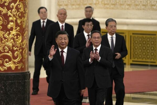 FILE - New members of the Politburo Standing Committee, front to back, President Xi Jinping, Li Qiang, Zhao Leji, Wang Huning, Cai Qi, Ding Xuexiang, and Li Xi arrive at the Great Hall of the People in Beijing, Sunday, Oct. 23, 2022. The installation of new leaders and the need to shore up a flagging economy will dominate the annual session of China's rubber-stamp parliament that kicks-off Sunday, March 5, 2023. (AP Photo/Ng Han Guan, File)