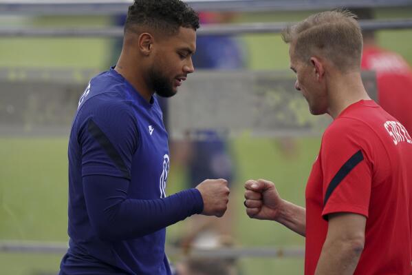 United States' goalkeeper Zack Steffen, left, greets a trainer during a training session ahead of the World Cup 2022 qualifying soccer match against Jamaica in Kingston, Monday, Nov. 15, 2021.(AP Photo/Fernando Llano)