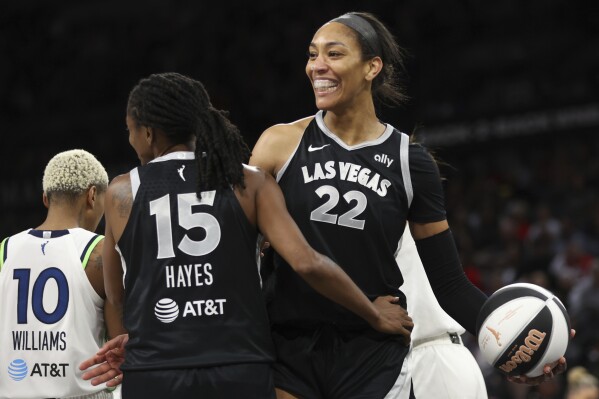 Las Vegas Aces center A'ja Wilson (22) and guard Tiffany Hayes (15) celebrate after scoring during the first half of a WNBA basketball game Tuesday, June 11, 2024 in Las Vegas. (Ellen Schmidt/Las Vegas Review-Journal via AP)