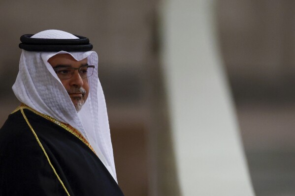 FILE - Bahrain's Crown Prince and Prime Minister Salman bin Hamad Al Khalifa pays his respects to the coffin of Britain's Queen Elizabeth, following her death, during her lying-in-state at Westminster Hall, in London, Sunday Sept. 18, 2022. The websites of two government ministries in Bahrain briefly became inaccessible Tuesday, Nov. 21, 2023, after a statement claimed hackers took them down over the island kingdom's stance on the ongoing Israel-Hamas war.(John Sibley/Pool via AP, File)