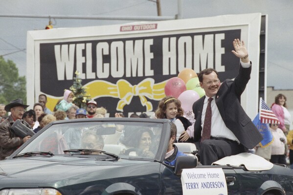 FILE - Former hostage Terry Anderson waves to the crowd as he rides in a parade in Lorain, Ohio, June 22, 1992. Anderson, the globe-trotting Associated Press correspondent who became one of America’s longest-held hostages after he was snatched from a street in war-torn Lebanon in 1985 and held for nearly seven years, died Sunday, April 21, 2024. He was 76. (AP Photo/Mark Duncan, File)