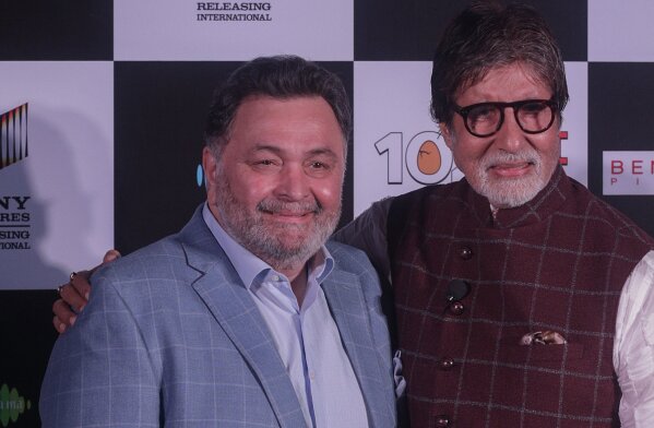 FILE- In this April 19, 2018 file photo, Bollywood actor Rishi Kapoor, left poses with actor Amitabh Bachchan the song launch of film '102 Not Out' in Mumbai, India. Rishi Kapoor, a top Indian actor and a scion of Bollywood’s most famous Kapoor family, has died after a battle with cancer. He was 67. (AP Photo/Rafiq Maqbool, File)