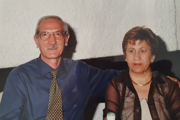 This undated photo provided by the family in April 2020 shows Enrico Giacomoni and his wife, Giulia Chiodi. The last time Roberto Giacomoni saw his 80-year-old father Enrico, he gently helped him up from bed, put his socks, shoes and jacket on, and walked him out to the paramedics who had come to take him to the hospital because he was having trouble breathing. (Courtesy of Giacomoni family via AP)