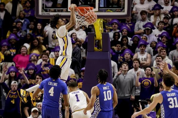 LSU forward Alex Fudge (3) dunks over Kentucky forward Daimion Collins (4) and guard Davion Mintz (10) in the first half of an NCAA college basketball game in Baton Rouge, La., Tuesday, Jan. 4, 2022. (AP Photo/Derick Hingle)