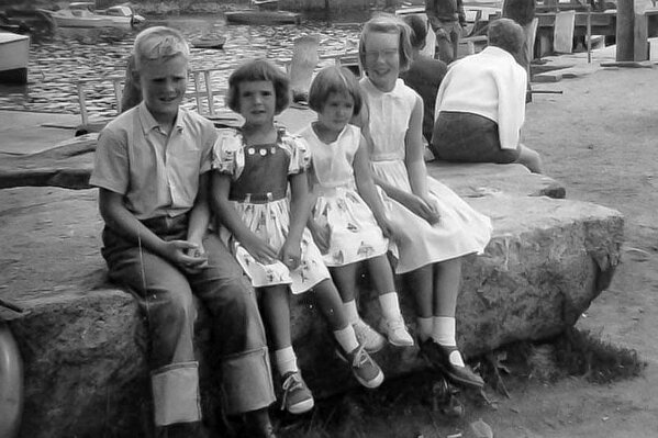 In this 1960 photo provided by Joyce Smith and made by her late father Ronald Smith, Joanne Mellady, far right, sits with her siblings from left Fred Smith, Jean Smith Sinofsky and Joyce Smith in Rockport, Mass. Mellady, who received a double lung transplant in 2007, died of the coronavirus on March 30, 2020. She was 67. (Ronald Smith via AP)
