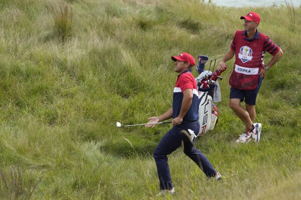 FILE - Team USA's Brooks Koepka hits from the rough on the third hole during a Ryder Cup singles match at the Whistling Straits Golf Course Sunday, Sept. 26, 2021, in Sheboygan, Wis. Koepka is the only player from LIV Golf playing in this year's Ryder Cup outside Rome on Sept. 29-Oct. 1, 2023.(AP Photo/Charlie Neibergall, File)