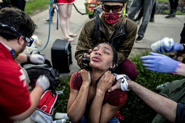 A protester receives care from street medics in Minneapolis, Saturday, May 30, 2020. Protests continue across the country over the death of George Floyd, a black man who died after being restrained by Minneapolis police officers on May 25. (Khadejeh Nikouyeh/News & Record via AP)/News & Record via AP)