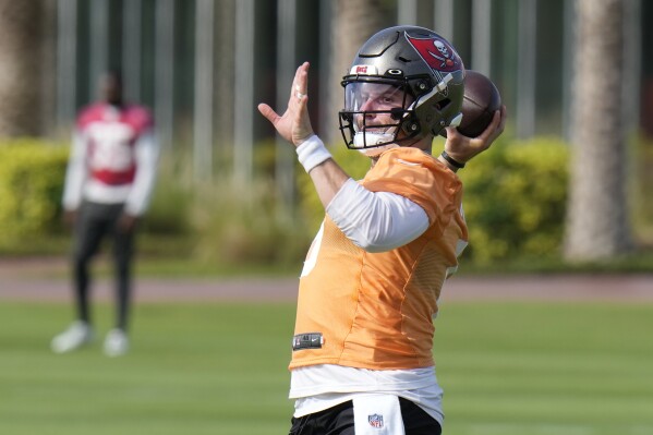 FILE - Tampa Bay Buccaneers quarterback Baker Mayfield throws during an NFL football practice Thursday, June 15, 2023, in Tampa, Fla. The competition between Baker Mayfield and Kyle Trask to replace Tom Brady is extending into training camp. (AP Photo/Chris O'Meara, File)