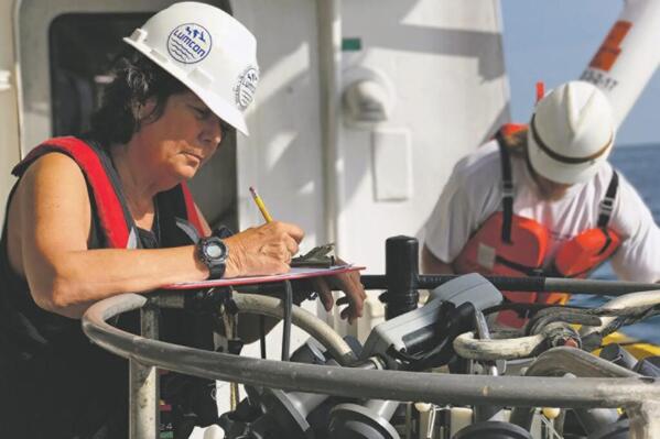 This undated photo provided LUMCON shows Nancy Rabalais recording data during a cruise aboard the R/V Pelican in the Gulf of Mexico to study hypoxia.   Authorities say a relatively sluggish Mississippi River has led to a smaller than average dead zone in the Gulf of Mexico — an area where there's too little oxygen to support marine life. The National Oceanic and Atmospheric Administration says 2022 measurement cruise found it to be 3,275 square miles. That's just under 70 percent of the area predicted in early June. (LUMCON via AP)