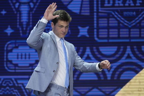 North Carolina quarterback Drake Maye walks on stage during the first round of the NFL football draft, Thursday, April 25, 2024, in Detroit. (AP Photo/Jeff Roberson)