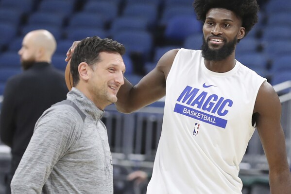 FILE - Orlando Magic forward Jonathan Isaac, right, smiles as he warms up beside assistant coach Nate Tibbetts, left, on the court before an NBA basketball game against the Boston Celtics in Orlando, Fla., Jan. 23, 2023. The Phoenix Mercury are finalizing a deal with Tibbetts to make him the team’s new coach a person familiar with the situation said Monday, Oct. 16, 2023. The person spoke to The Associated Press on condition of anonymity because no announcement had been made. (Stephen M. Dowell/Orlando Sentinel via AP, File)