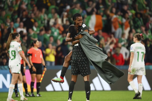 Nigeria's Blessing Demehin, back, celebrate with Nigeria's Osinachi Ohale after the Women's World Cup Group B soccer match between Ireland and Nigeria in Brisbane, Australia, Monday, July 31, 2023. (AP Photo/Tertius Pickard)