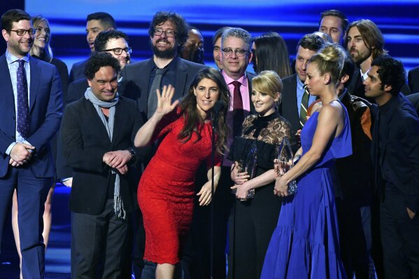 
              FILE - In this Jan. 18, 2017 file photo, the cast and crew of "The Big Bang Theory" accept the award for favorite network TV comedy at the People's Choice Awards at the Microsoft Theater in Los Angeles. Champagne is briefly replacing scripts on the set of "The Big Bang Theory." A nondescript building on the sprawling Warner Brothers production lot in Burbank known as Stage 25 was renamed Thursday, Feb. 7, 2019, for the CBS sitcom that called it home for 12 years and will soon depart. (Photo by Vince Bucci/Invision/AP, File)
            