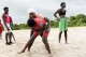 Coach Isabelle Sambou, 43 years old, rear, two-time Olympian and nine-time African wrestling champion, explains a move to a young woman during a wrestling training in Mlomp, southern Senegal, Wednesday, July 10, 2024. (AP Photo/Sylvain Cherkaoui)