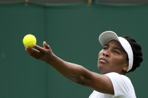 Venus Williams of the US serves to Romania's Mihaela Buzarnescu during the women's singles first round match on day two of the Wimbledon Tennis Championships in London, Tuesday June 29, 2021. (AP Photo/Alastair Grant)