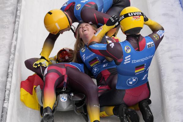 Max Langenhan, Sascha Benecken, Toni Eggert and Anna Berreiter of Germany celebrate winning the team relay race at the Luge World Championships in Oberhof, Germany, Sunday, Jan. 29, 2023. (AP Photo/Matthias Schrader)