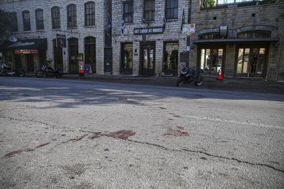 Blood stains remain on 6th Street after an early morning shooting on Saturday, June 12, 2021 in downtown Austin, Texas. Authorities say someone opened fire on the busy entertainment district wounding several people before getting away. (Aaron Martinez/Austin American-Statesman via AP)