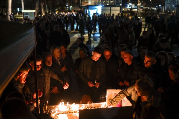 People wait in lines to light candles in the town of Kocani, North Macedonia, Sunday, March 16, 2025, following a massive fire in the nightclub early Sunday. (AP Photo/Armin Durgut)