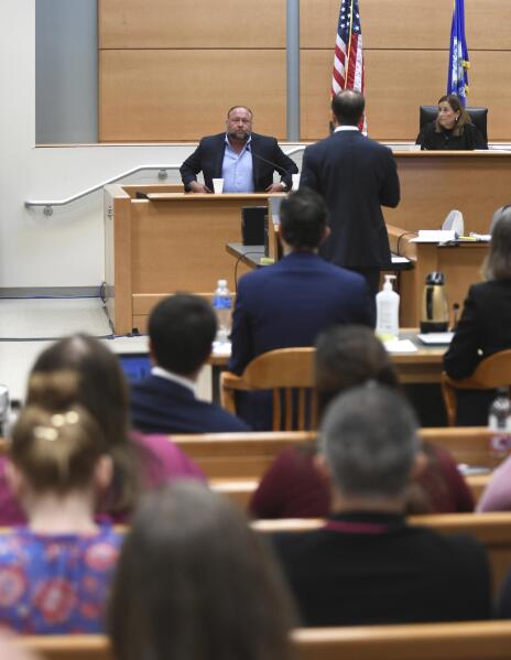 Conspiracy theorist Alex Jones takes the witness stand to testify at the Sandy Hook defamation damages trial at Connecticut Superior Court in Waterbury, Conn. Thursday, Sept. 22, 2022. Jones was found liable last year by default for damages to plaintiffs without a trial, as punishment for what the judge called his repeated failures to turn over documents to their lawyers. The six-member jury is now deciding how much Jones and Free Speech Systems, Infowars’ parent company, should pay the families for defaming them and intentionally inflicting emotional distress. (Tyler Sizemore/Hearst Connecticut Media via AP, Pool)