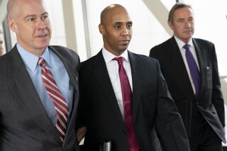 
              FILE--In this April 1, 2019, file photo, former Minneapolis police officer Mohamed Noor, center, leaves the Hennepin County Government Center after the first day of jury selection with his attorneys Thomas Plunkett, left, and Peter Wold, in Minneapolis, Minn. Testimony in Noor's trial has shined a light on officers' actions at the scene and raised questions about whether they were trying to protect one of their own. The incident commander turned her body camera off when talking to Noor in the moments after the July 2017 shooting of Justine Ruszczyk Damond, while other officers who responded told him not to say a word, according to prosecutors and court testimony. (Renee Jones Schneider/Star Tribune via AP, File)
            