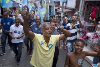 FILE - Former soccer player Romário campaigns as a gubernatorial candidate at the Complexo de Alemao slum, in Rio de Janeiro, Brazil, Oct. 4, 2018. Romário returned to training on Thursday, April 25, 2024, at age 58, almost two decades after he retired from the sport, with Rio's America soccer club, of which he is the president. (AP Photo/Silvia Izquierdo, File)