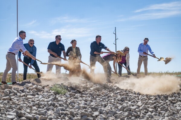 Dignitaries, including U.S. Secretary of the Interior Deb Haaland, center, break ground on the new SunZia transmission line project in Corona, N.M., on Friday, Sept. 1, 2023. The SunZia project will stretch about 550 miles (885 kilometers) — funneling renewable energy to more populated areas in Arizona and California. (Jon Austria/The Albuquerque Journal via AP)