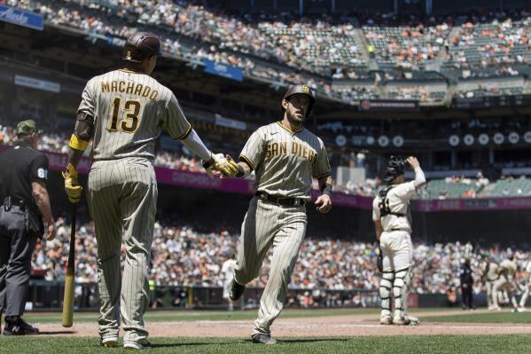 San Diego Padres' Jake Cronenworth, front right, celebrates with Manny Machado (13) after scoring against the San Francisco Giants during the fourth inning of a baseball game in San Francisco, Sunday, May 22, 2022. (AP Photo/John Hefti)